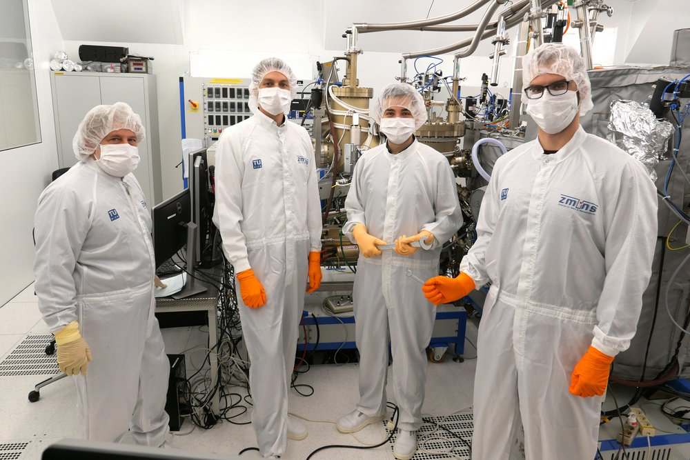 Gottfried Strasser, Benedikt Schwarz, Johannes Hillbrand and Nikola Opacak in protective suits and protective masks in the laboratory