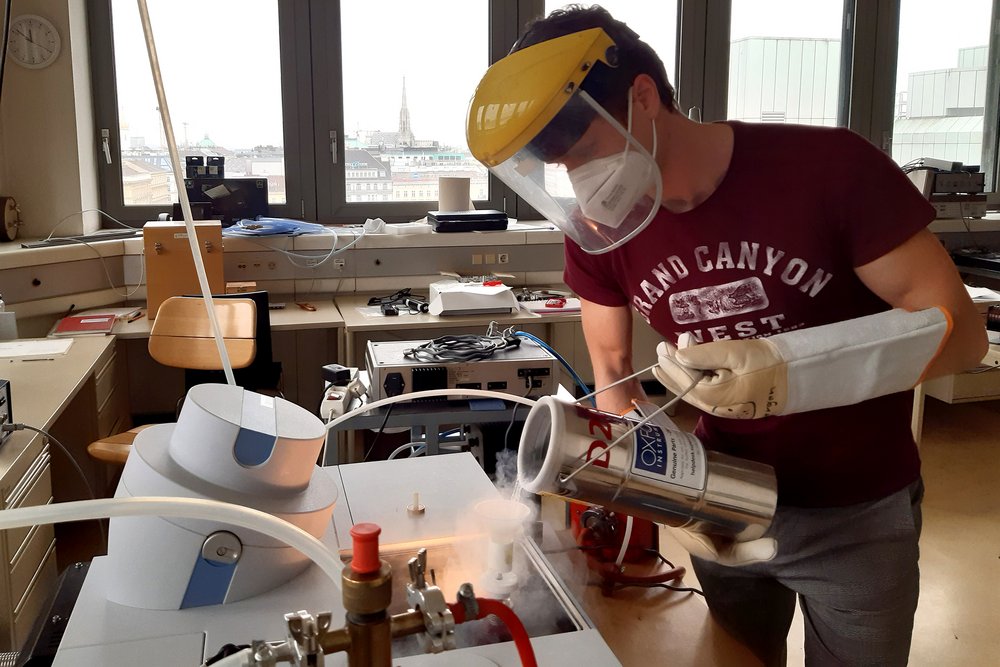 A scientist working with liquid nitrogen in the lab