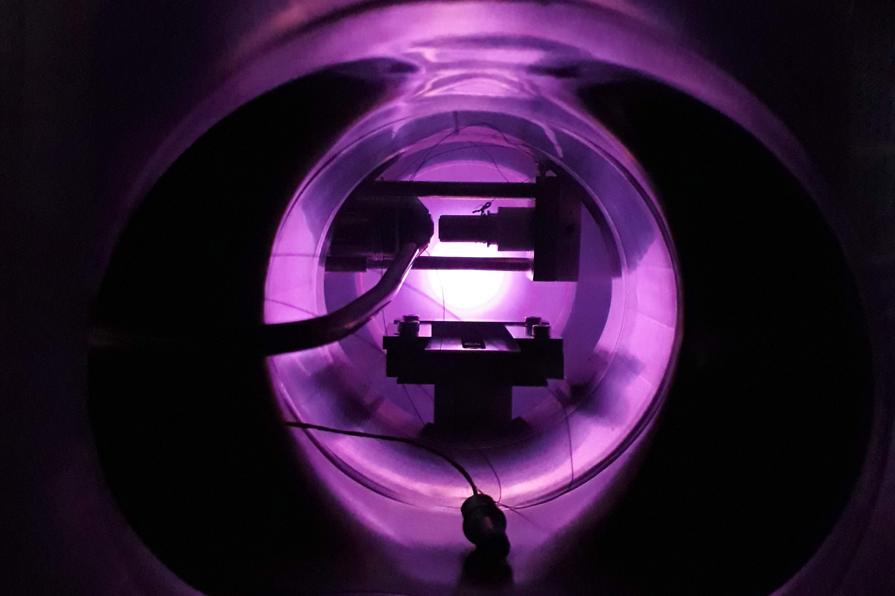 Vacuum chamber with purple glow.
