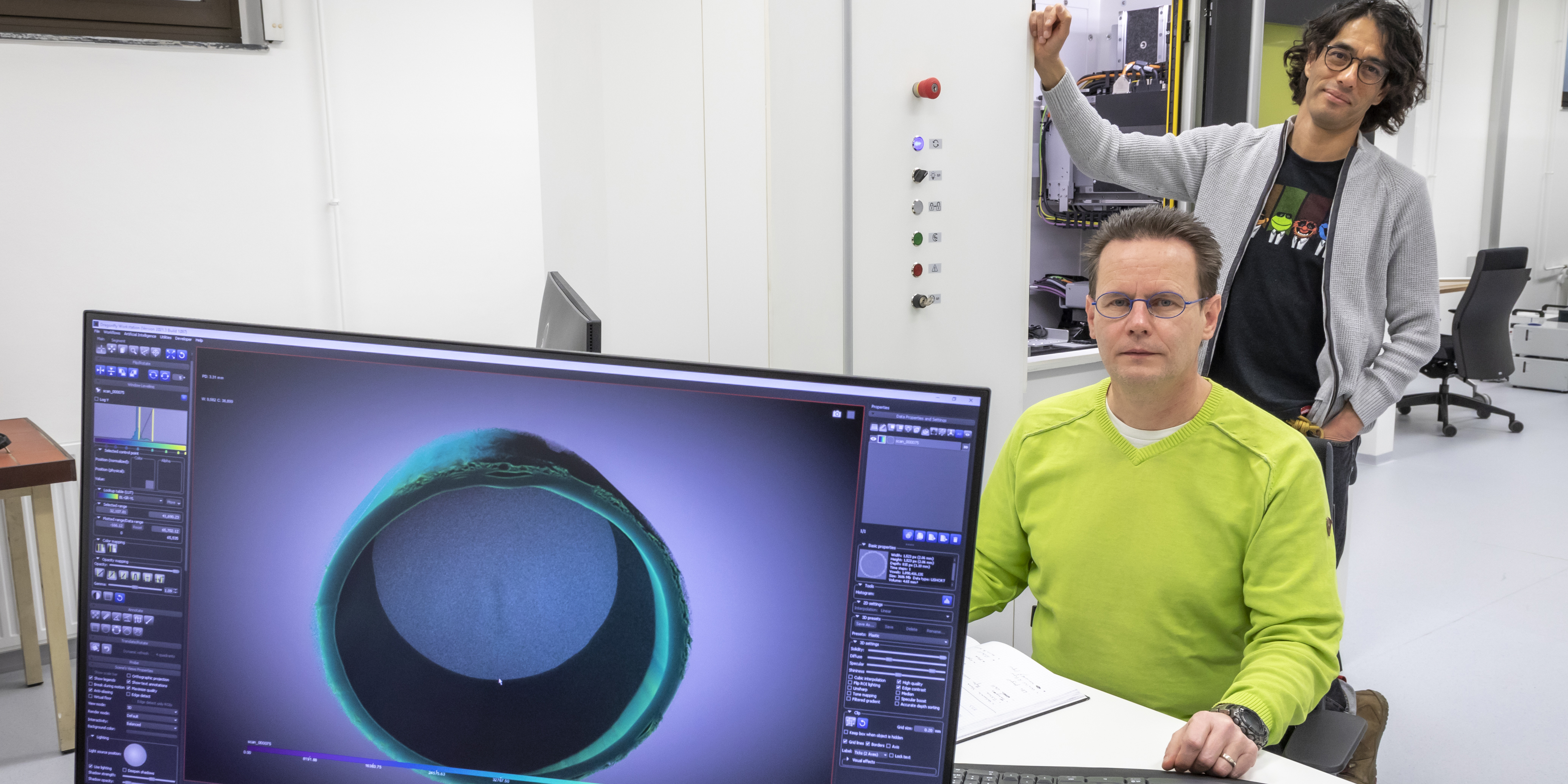 Two TU Graz researchers in front of a micro-CT